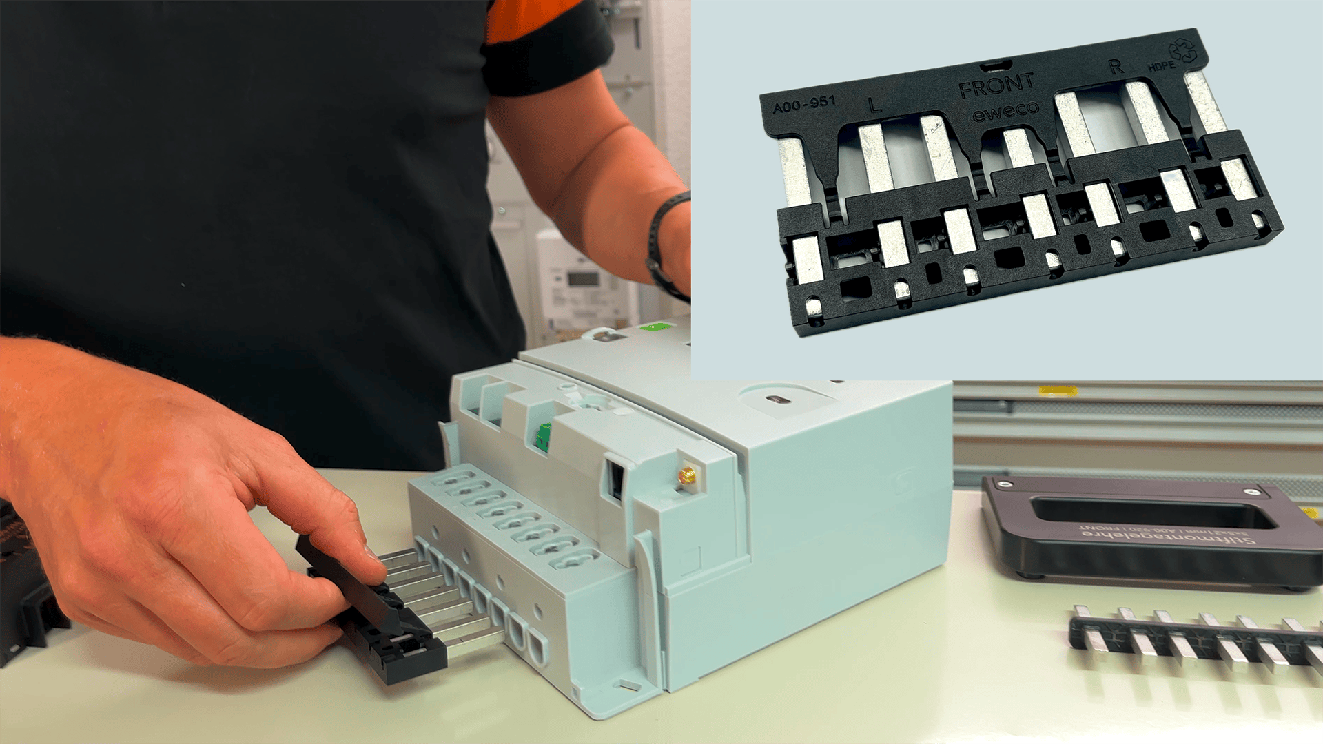 A person inserts a black plug into a gray electrical device. An inset shows a close-up of the plug with metal contacts and the word "FRONT" with directional arrows.