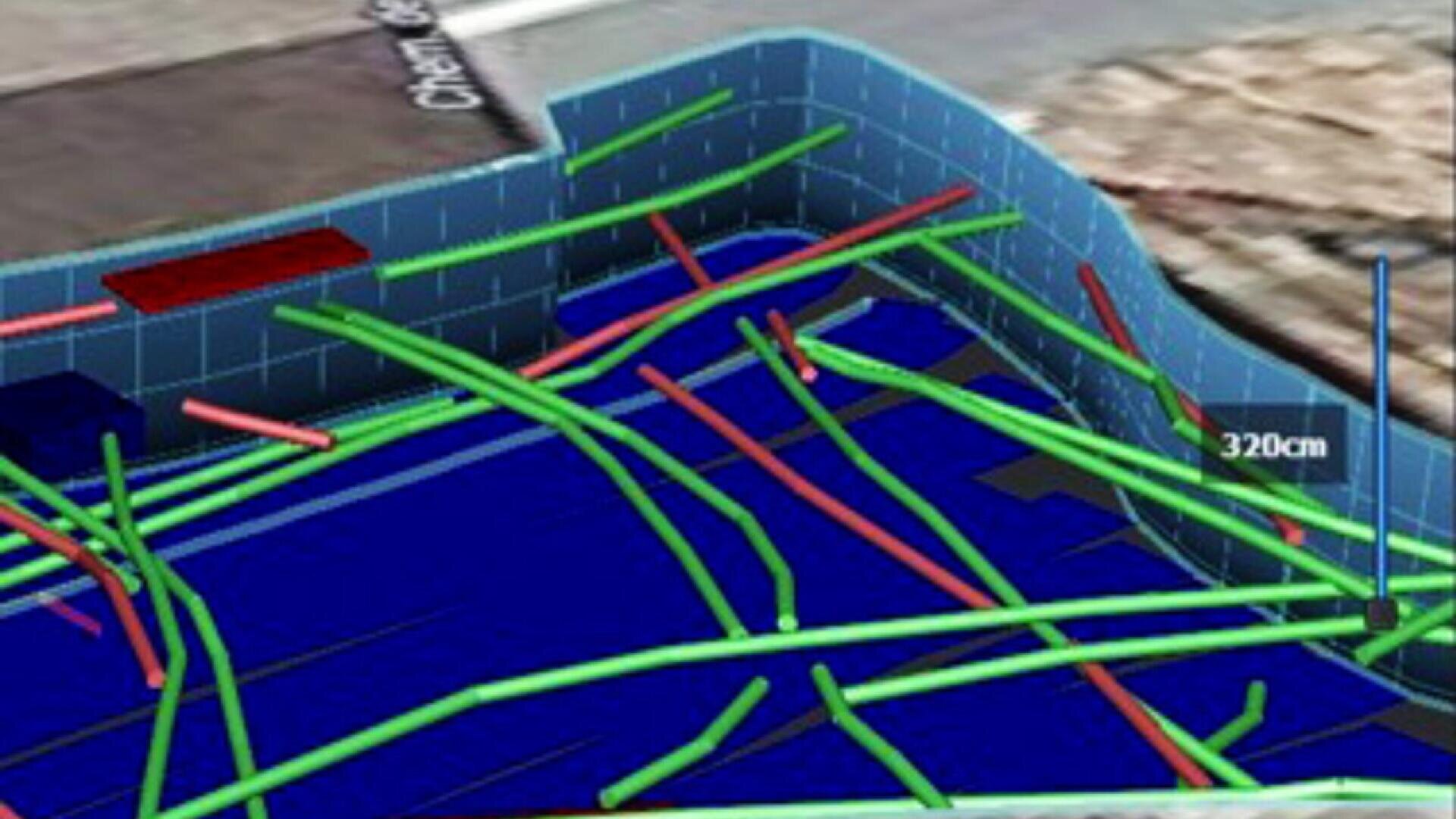 A 3D digital model showing intersecting green and red lines, possibly representing pipes or cables, inside a blue-walled structure with a marked height of 320 cm. Part of a street map appears in the background.